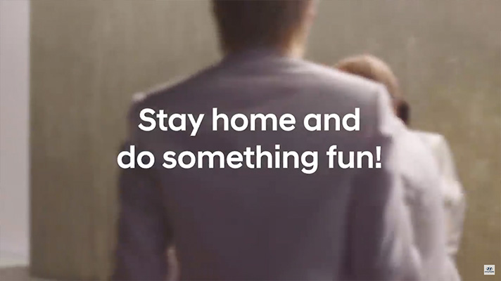 Scene from BTS collaboration video with words 'Stay home and do something fun!'