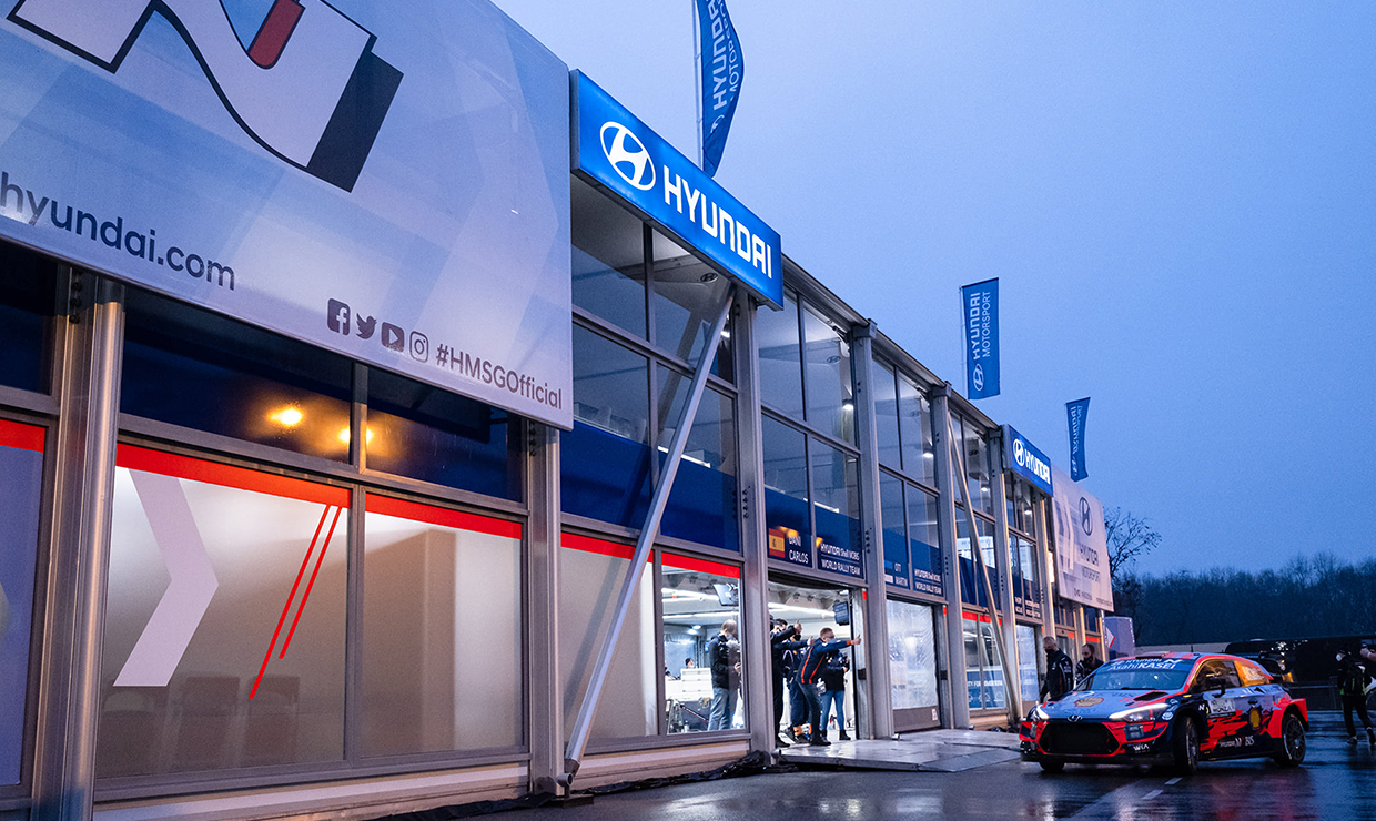 Image of Hyundai Motorsports racing car in front of service park