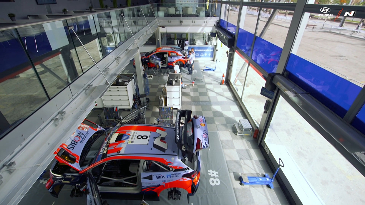 Two racing cars being serviced at Service Park