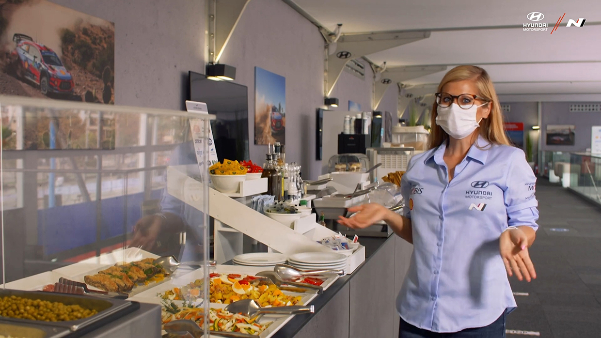 Mieke Vercammen standing in front of Service Park restaurant service desk