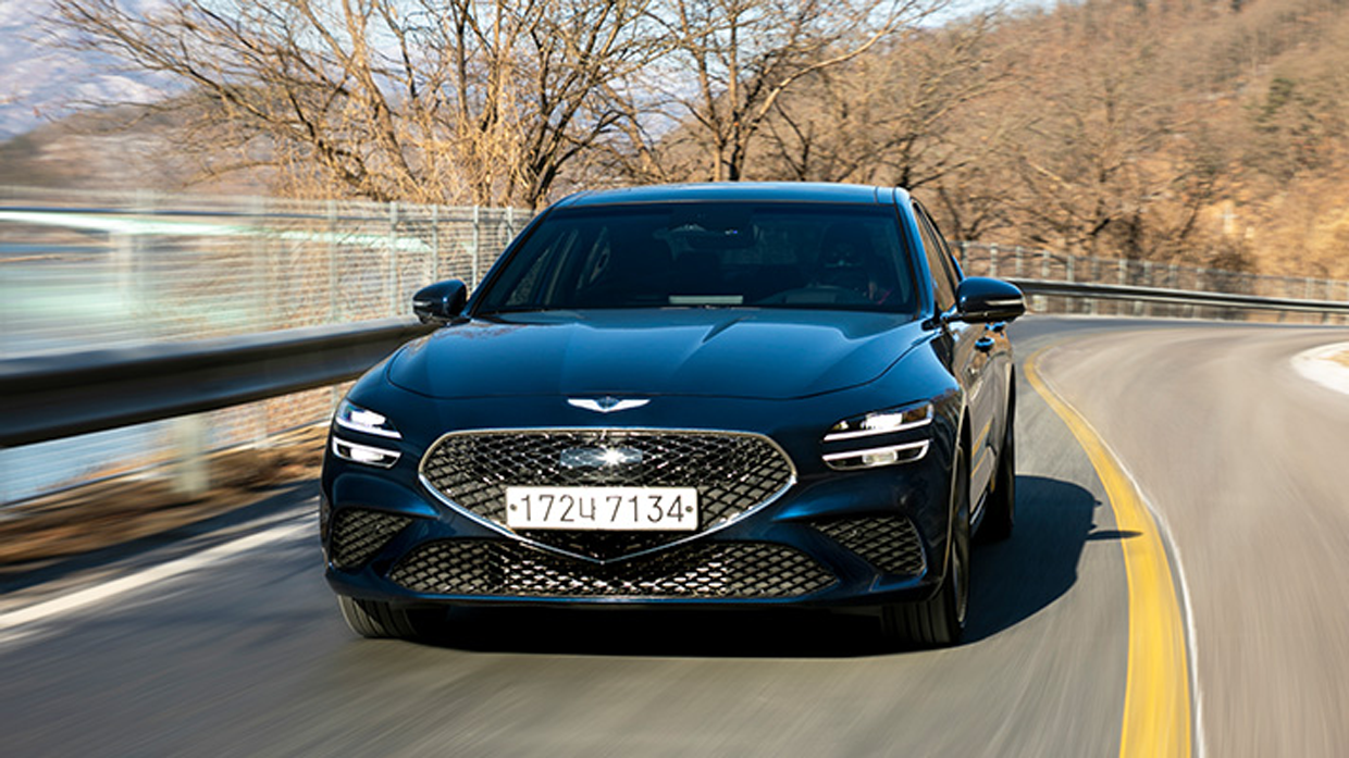 Front side image of tasman blue Genesis G70 driving