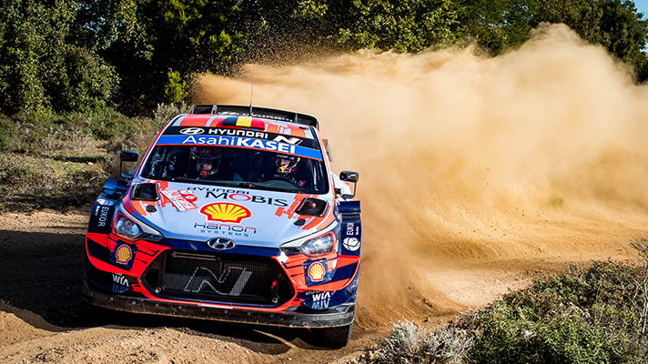 Hyundai Motorsports team racing car driving on the course spraying dirt and dust