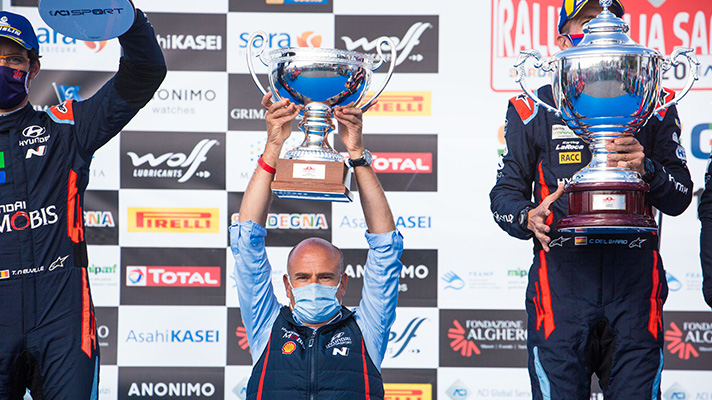 Hyundai Motor sports coach Andrea Adamo lifting champion trophy over his head