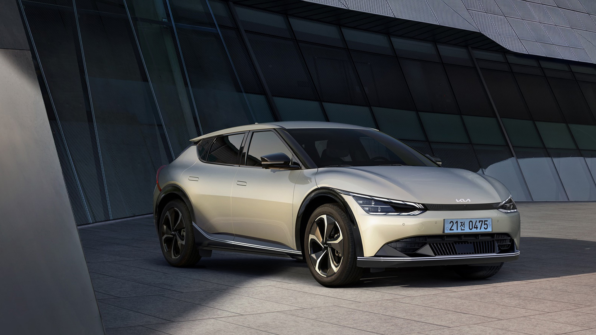 그늘진 건물앞 주차된 흰색 기아 EV6의 측면