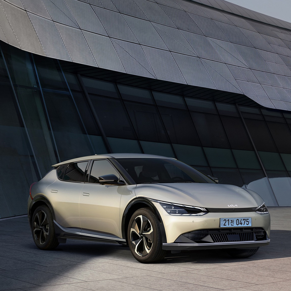 그늘진 건물앞 주차된 흰색 기아 EV6의 측면