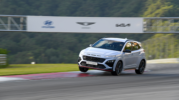 Hyundai white Kona N running on a track