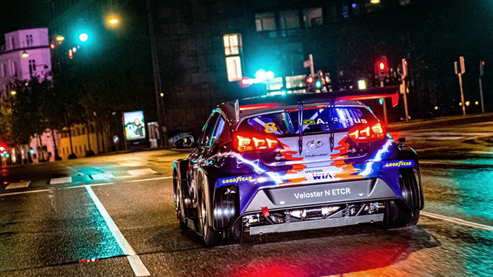 Rear view of Hyundai Veloster N ETCR racing machine on road