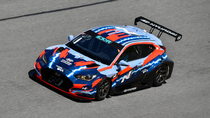 Hyundai Veloster N ETCR racing machine driving on track