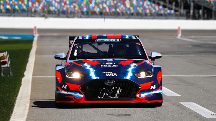 Front image of Hyundai ETCR racing machine driving on track