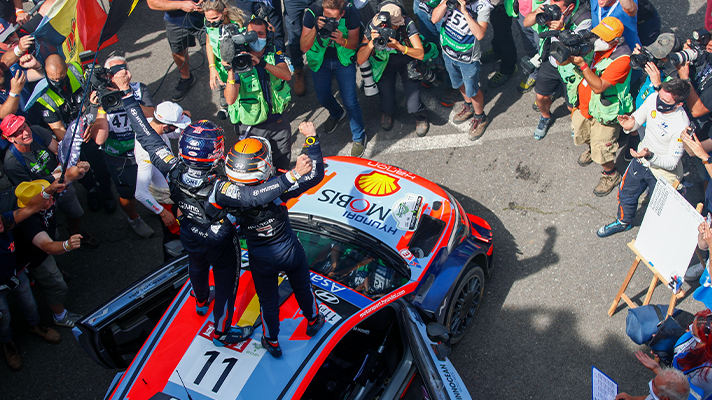 Drivers cheering on the racing car