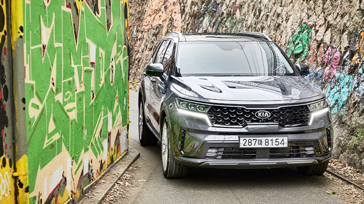 Front view of Kia Sorento coming out of a narrow alley