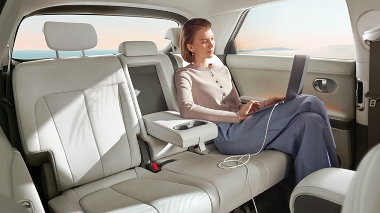 Image of Hyundai IONIQ 5 working on a computer in the back seat