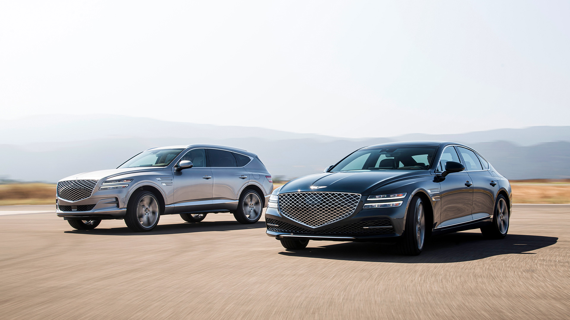 Two Genesis car standing in the sun