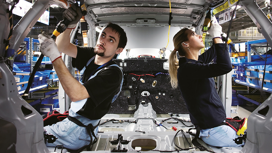 Two employees inspecting auto parts at Hyundai Motor's Czech plant