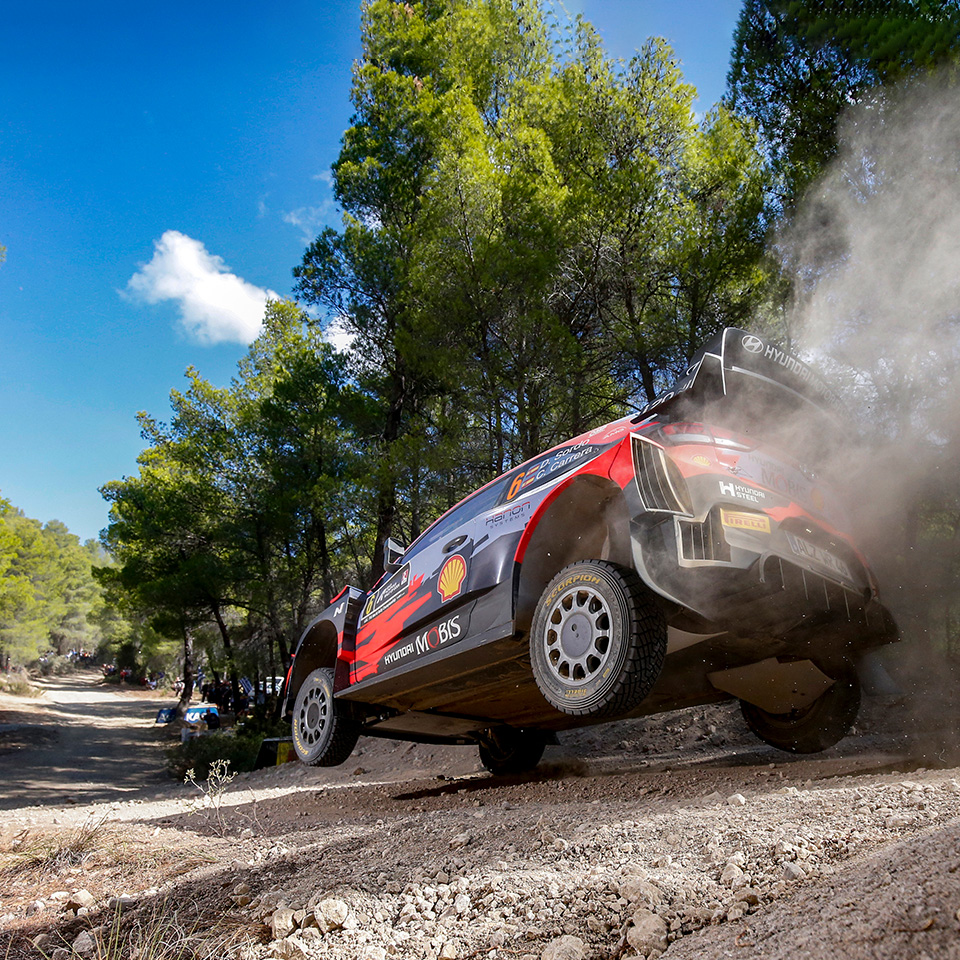 Rear side of WRC running on dirt road