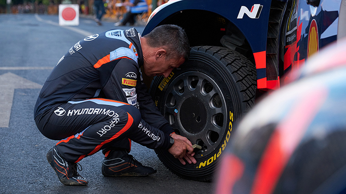 A picture of a driver setting a tire