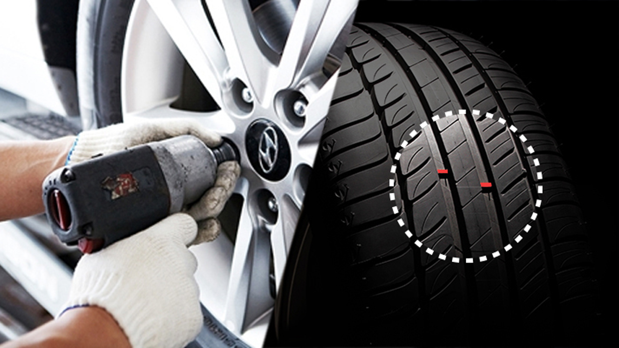 Image of a gloved mechanic changing a tire