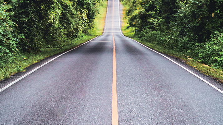 Image of a paved road in a mountain road