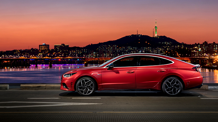 야경의 한강다리를 건너는 현대자동차 쏘나타 N의 모습