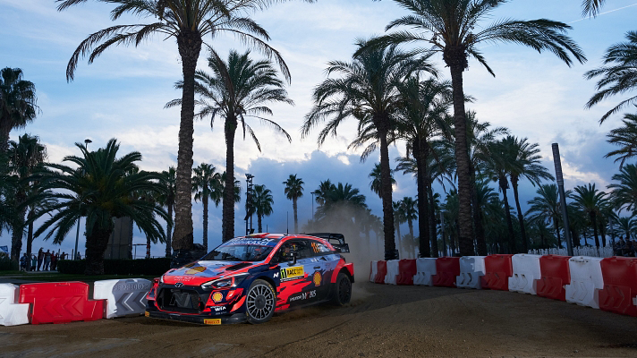 WRC car running along the coastal road