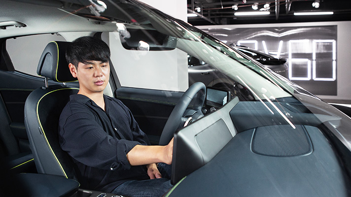 Seo Dae-il, senior manager, sitting in the driver's seat of GV6
