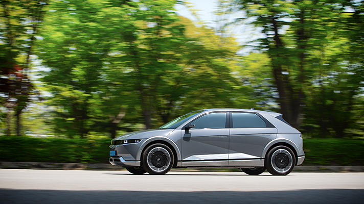 Side view of Hyundai IONIQ 5 running on the road