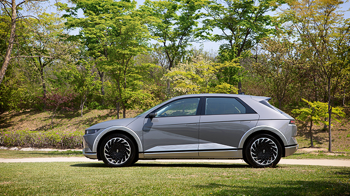 Side view of Hyundai IONIQ 5 parked on the lawn