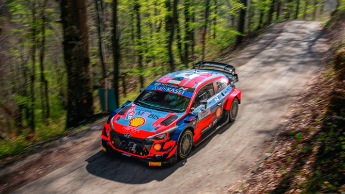Hyundai i20 Coupe WRC running on a narrow forest path