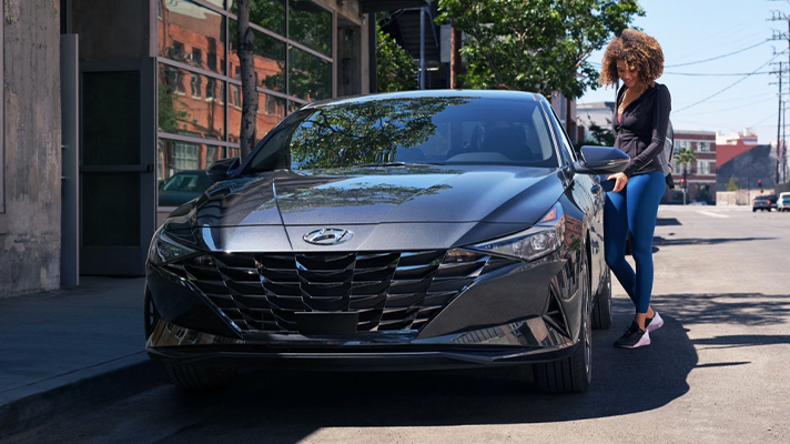 주차중인 아반떼의 차문을 현대 디지털 키로 열고 있는 모습