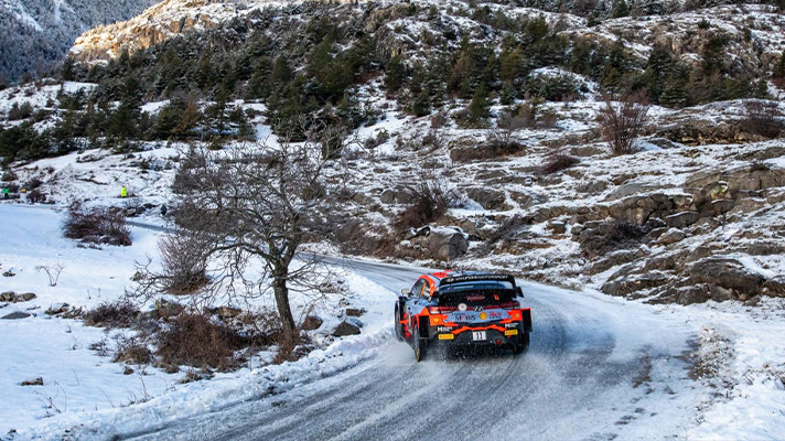 Hyundai Motorsport racing car breaks through the curved snowy course