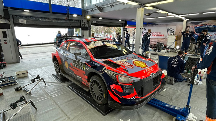 Hyundai Motorsports racing car at the service park with the rear tire missing