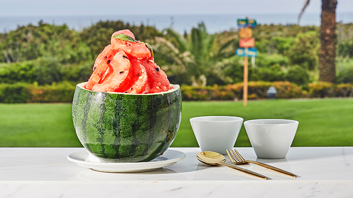 Apple watermelon shaved ice placed on an outdoor table