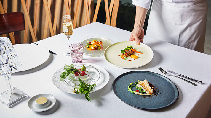 A chef serving in a French restaurant