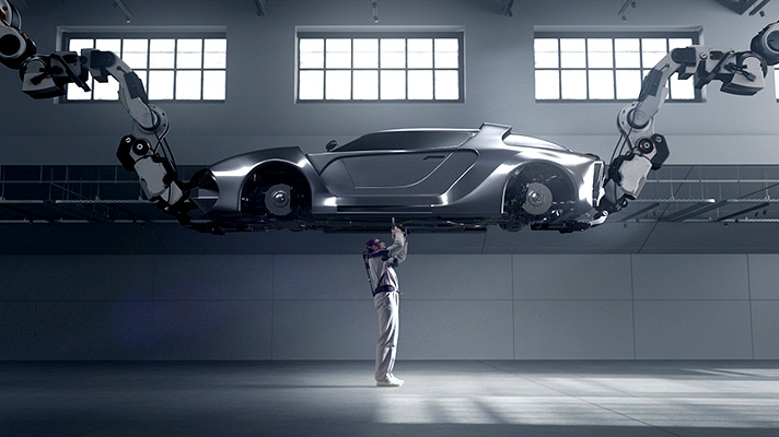 A worker wearing the VEX, an industrial wearable robot, inspecting a vehicle