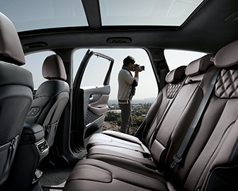 Man taking a picture with the inside of The New Santa Fe