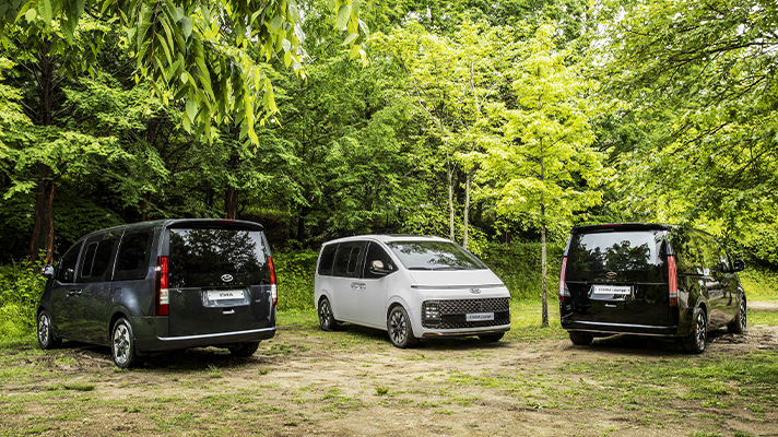 Three Hyundai STARIA parked in the campground