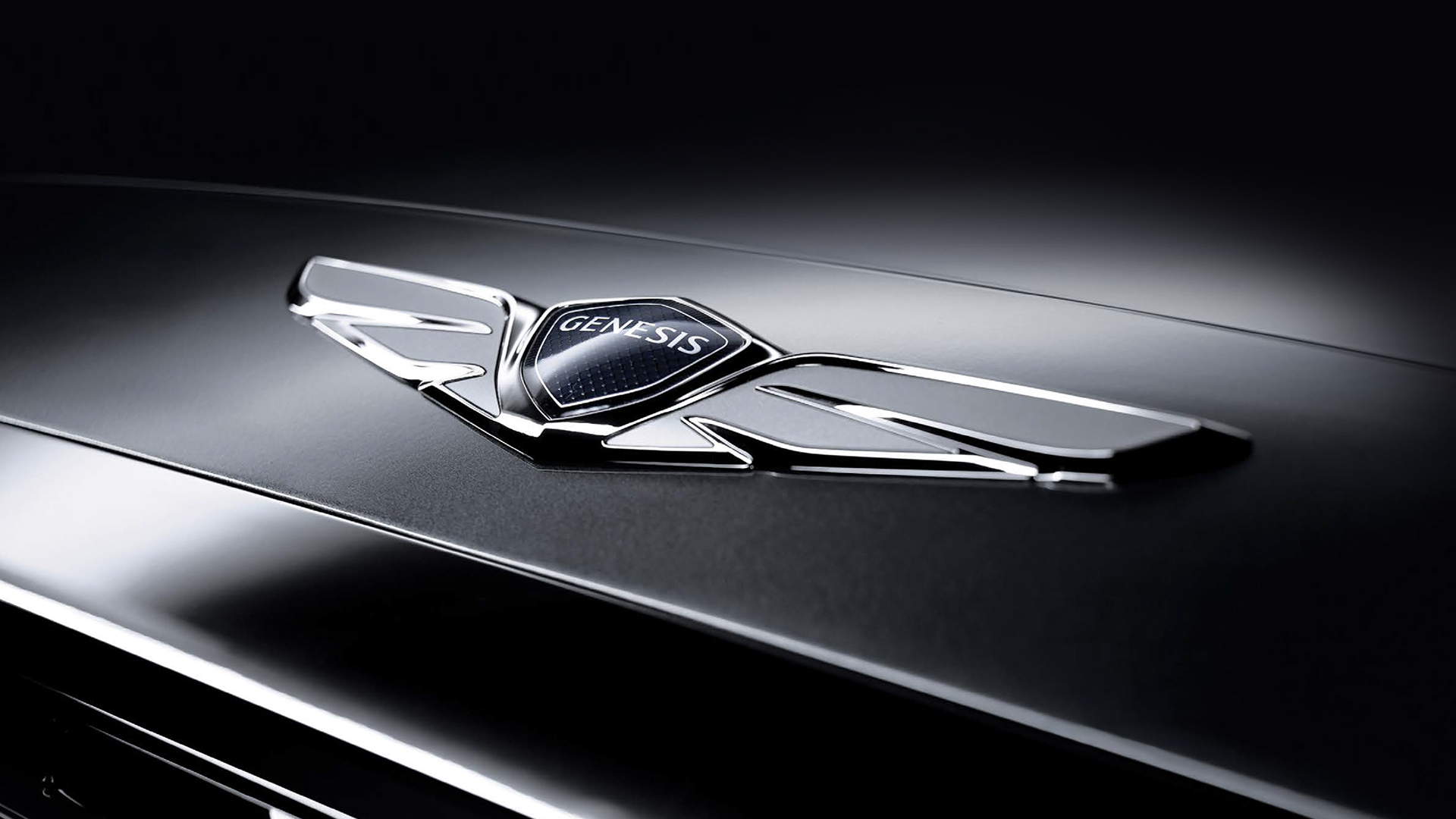 Close-up of the logo on the front bumper of a Genesis car