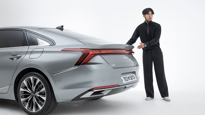 Senior researcher explaining the rear design of the Kia K8