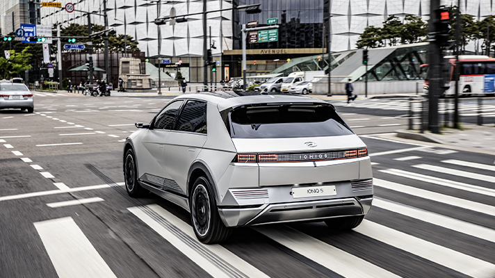 Rear view of Hyundai IONIQ 5 passing a crosswalk