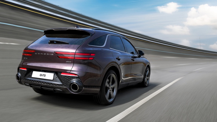 Rear angle view of the Genesis GV70 on a driving test track