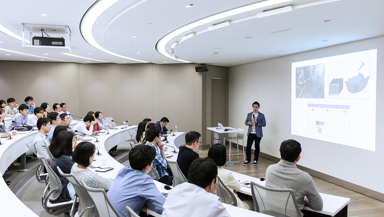 View of employees and audience giving a ppt presentation in the company