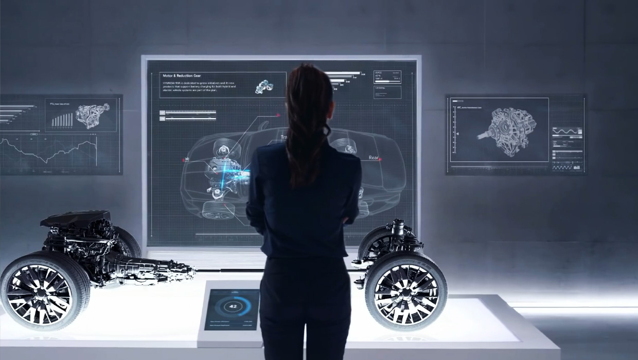 Rear view of a female employee looking at a perspective view of a car floating on the wall in a laboratory