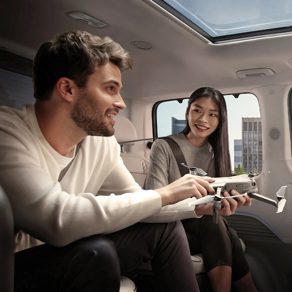 Multiracial workers holding a model airplane and having a conversation