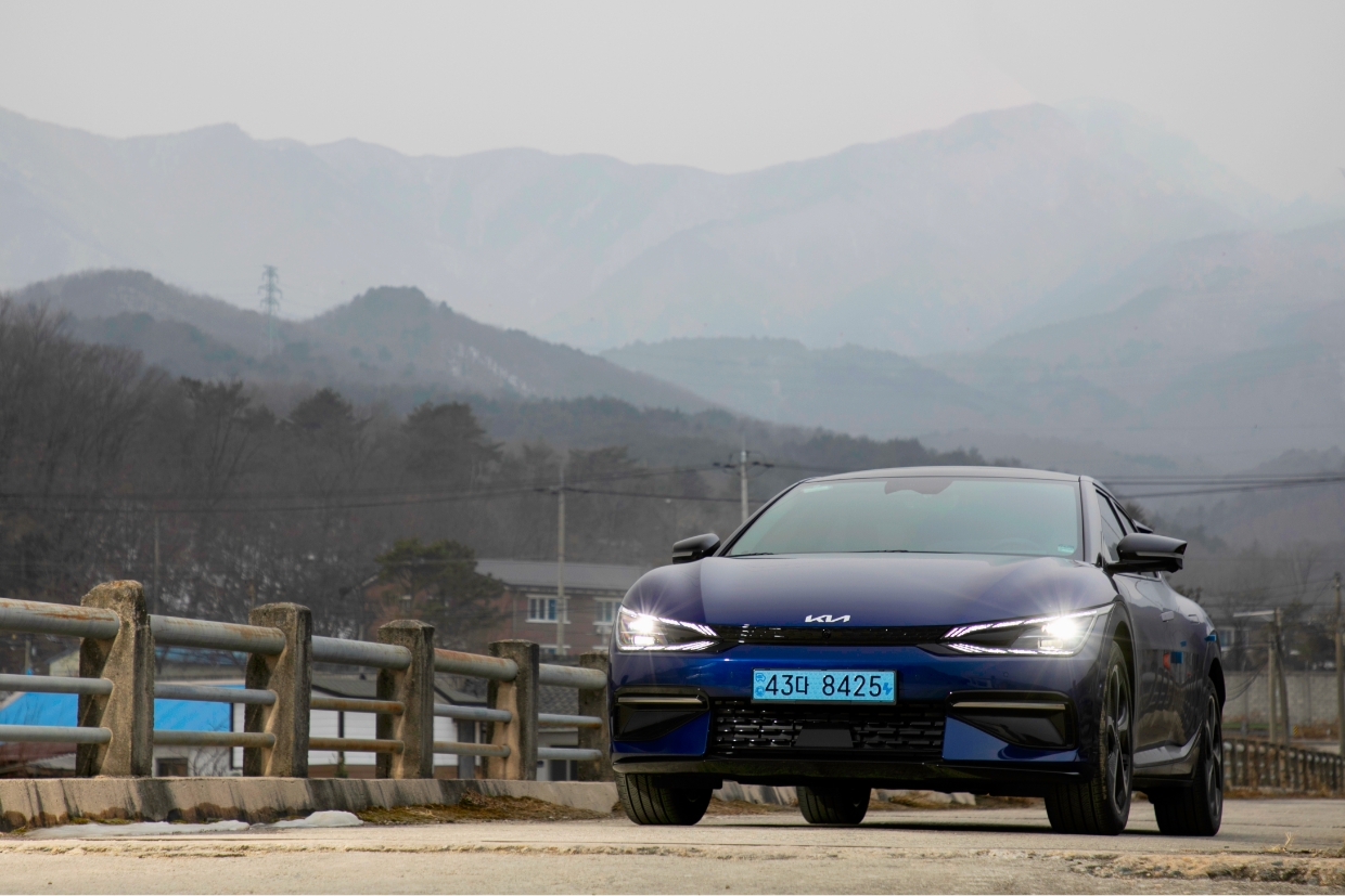 Kia EV6 standing on a rural bridge