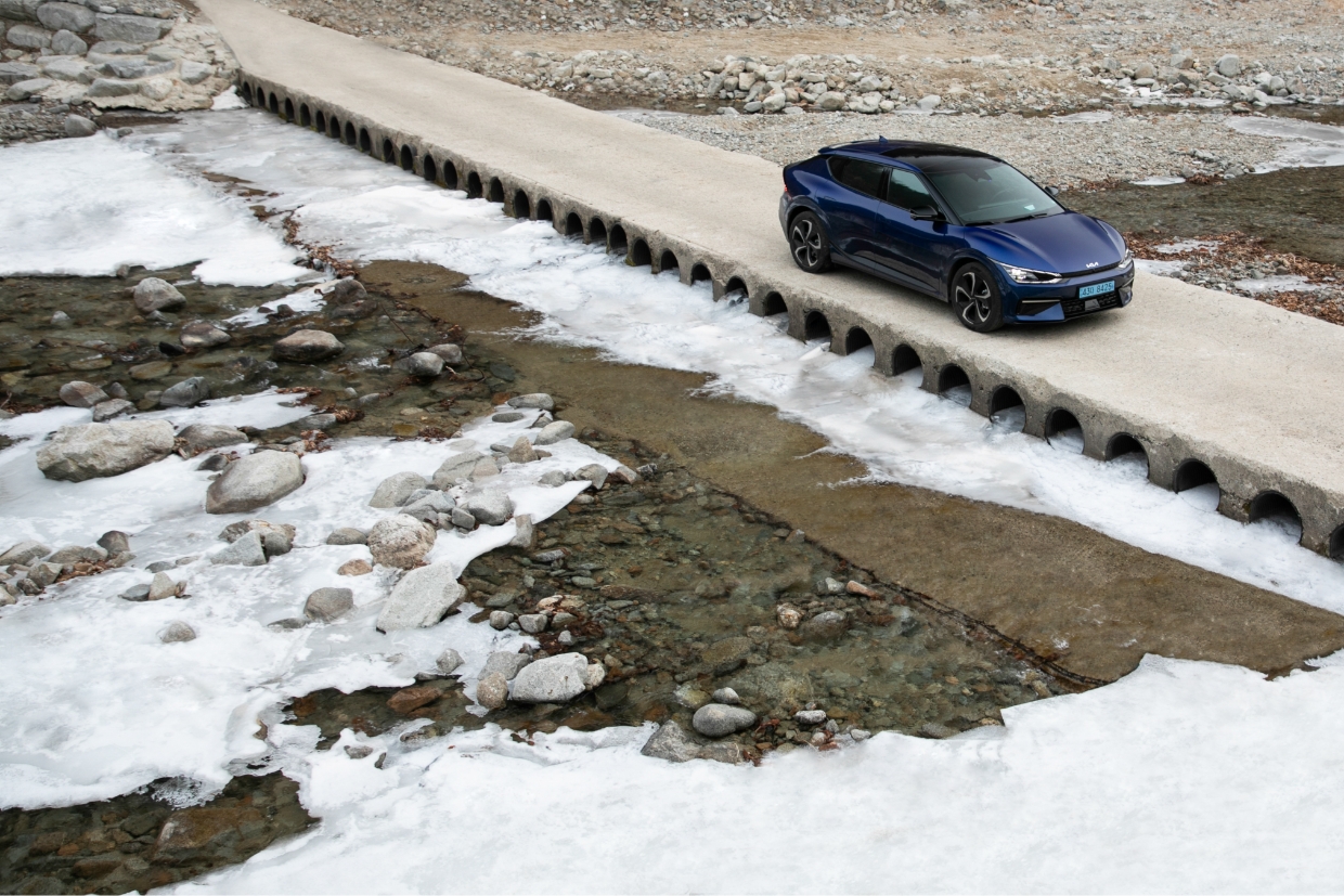 Kia EV6 driving on a country road