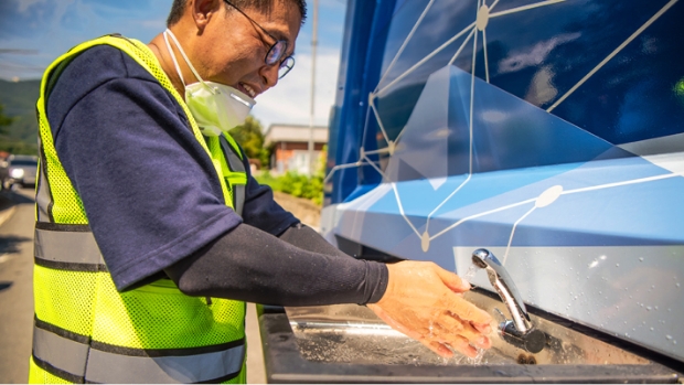 Sanitation engineer is washing his hands