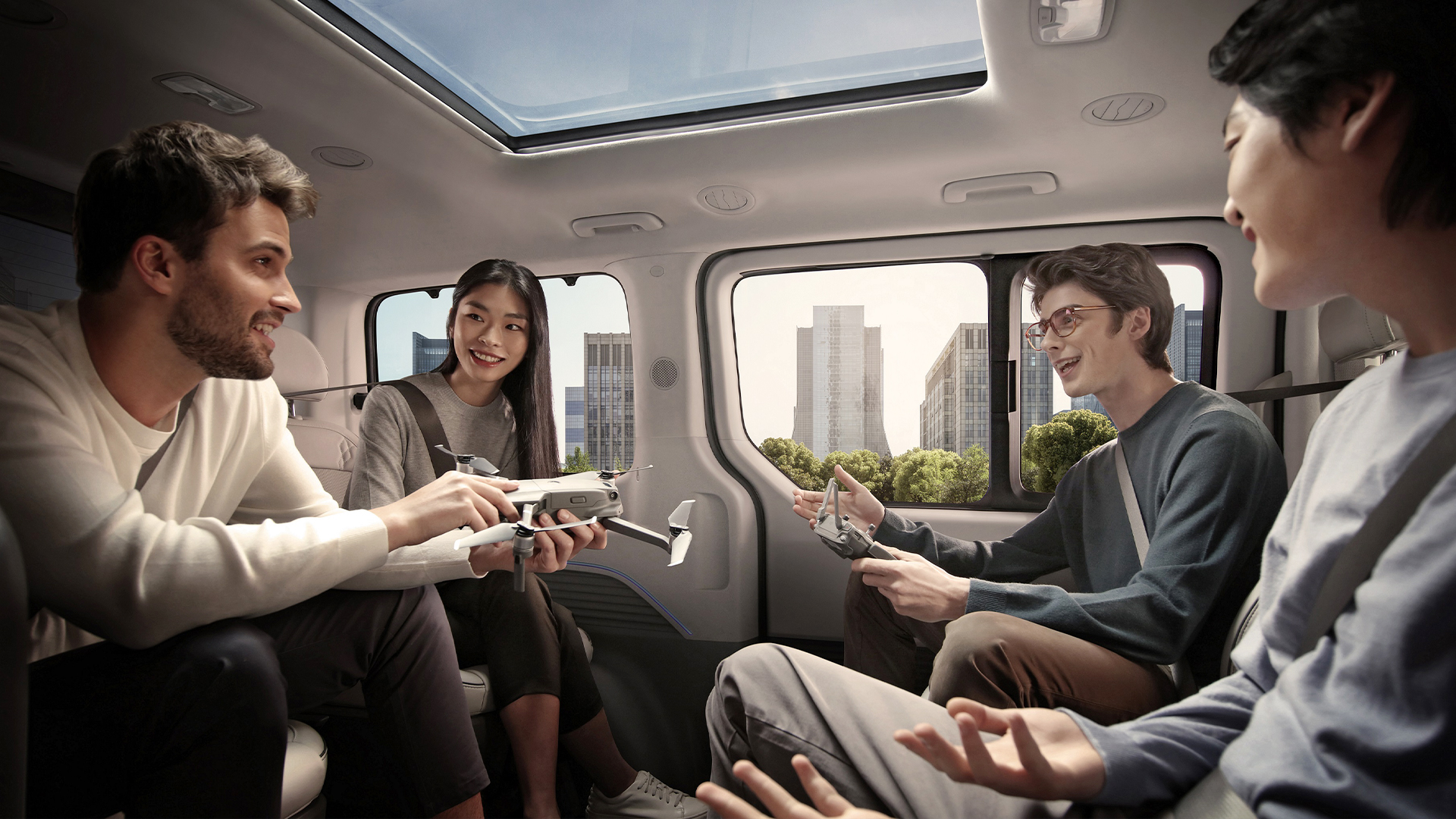 Multiracial employees holding model airplanes and talking freely