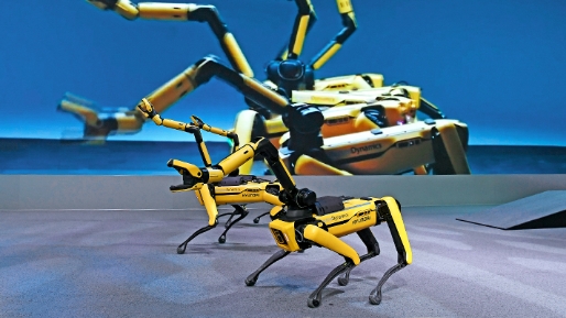 A person wearing a wearable robot assembles a car