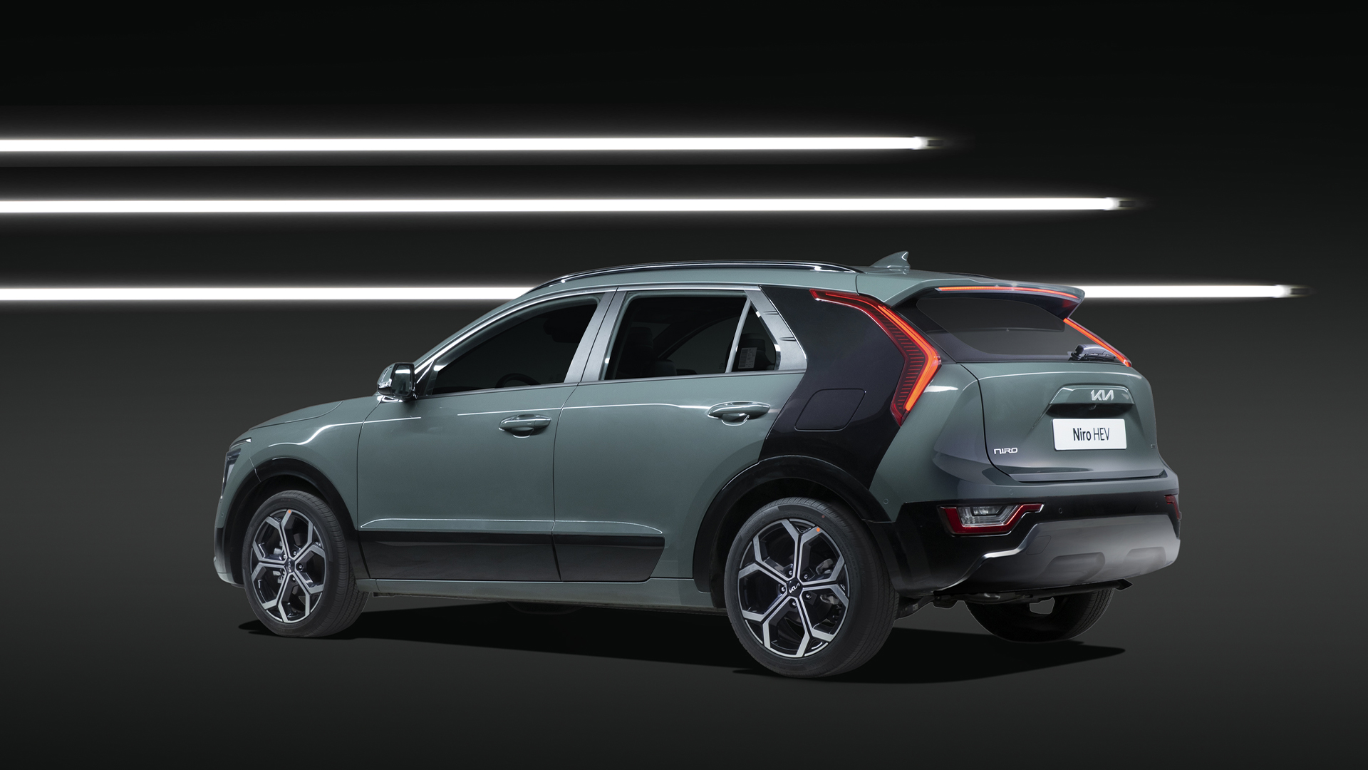 The rear side of the Niro against the backdrop of 3 rows of LED lights in black background