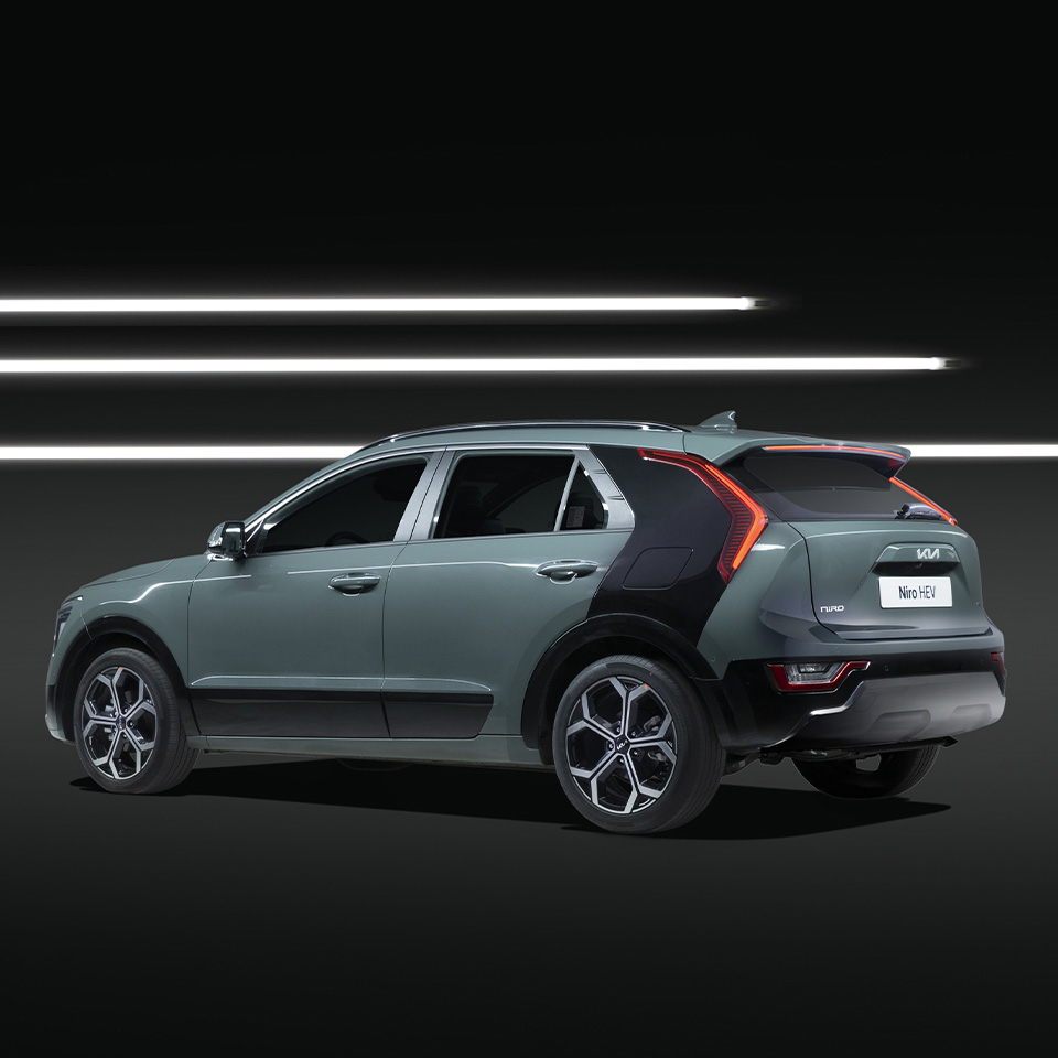 The rear side of the Niro against the backdrop of 3 rows of LED lights in black background